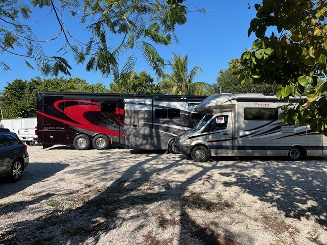 Lot with multiple RVs and a skid steer for unload help