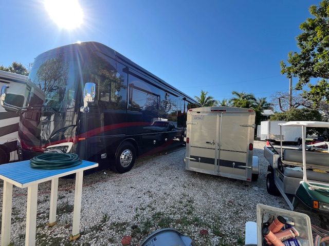 RV next to box trailer in storage